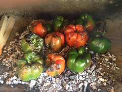 We are grilling or roasting peppers directly on ash wood embers.  This is a great technique to infuse wood flavoring directly to the peppers